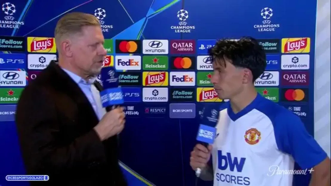 Peter Schmeichel interviewing Lisandro Martinez in front of a branded backdrop.