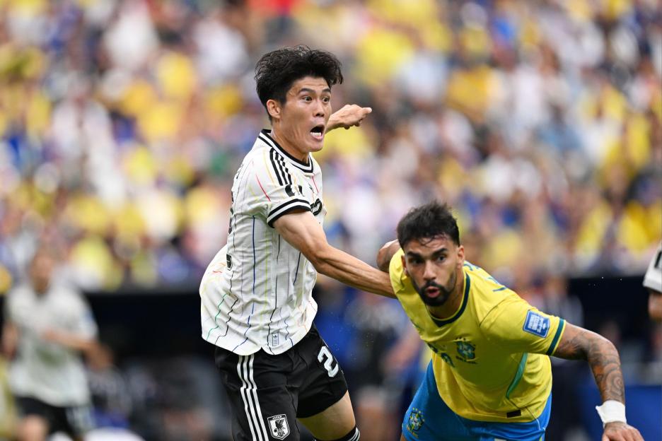 Japan's Takehiro Tomiyasu gesturing on the field during a FIFA World Cup 2026 match against Brazil.