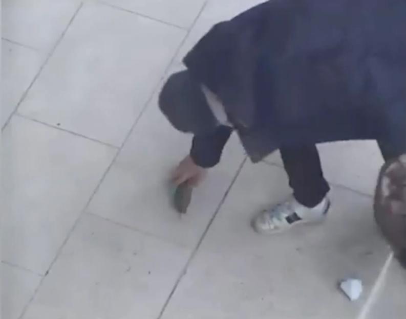 CCTV image of Julian Valente Pereira placing a fake stick of dynamite outside the MI5 headquarters.