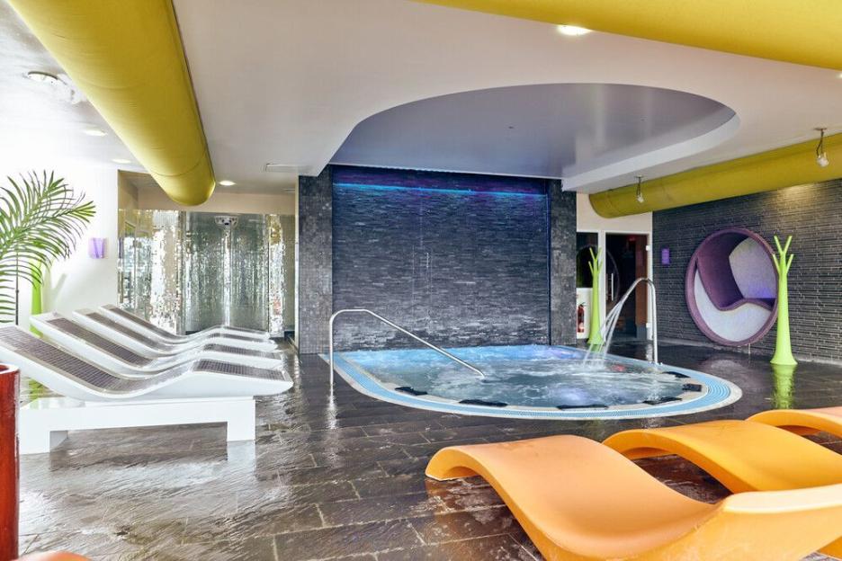 Ocean Spa at Butlin's Bognor Regis with a hot tub, lounge chairs, and a water feature.