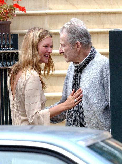 Kate Moss and Lucian Freud smiling and talking.