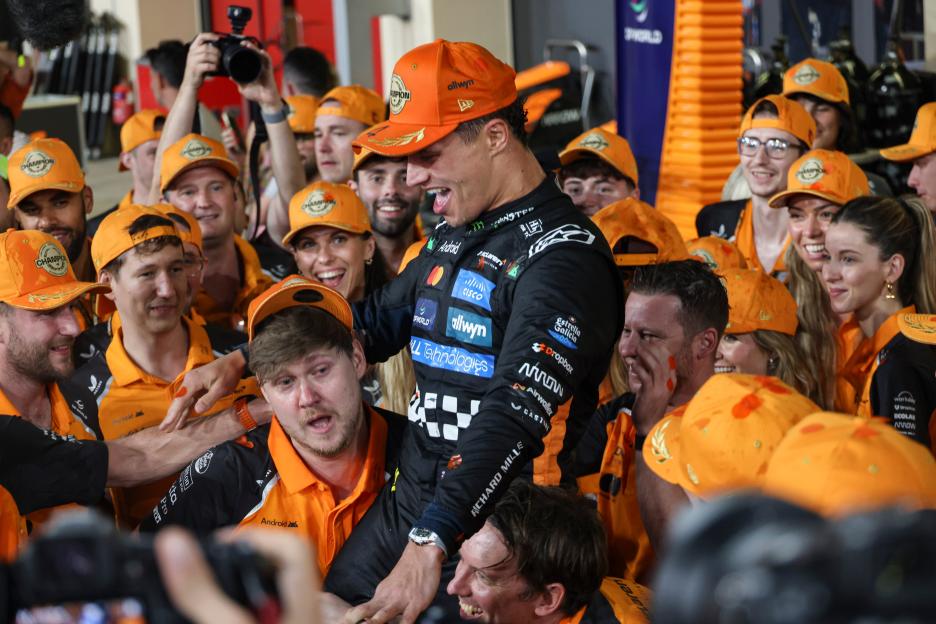 Lando Norris, F1 World Drivers Champion, celebrates with his McLaren team after the Abu Dhabi Grand Prix.