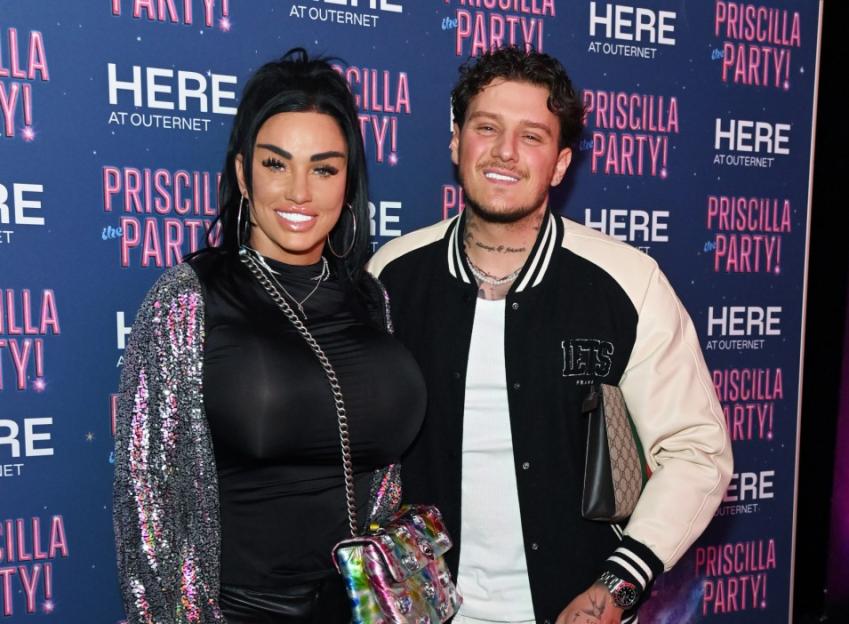 Katie Price and Carl Woods smiling at the "Priscilla The Party!" event.