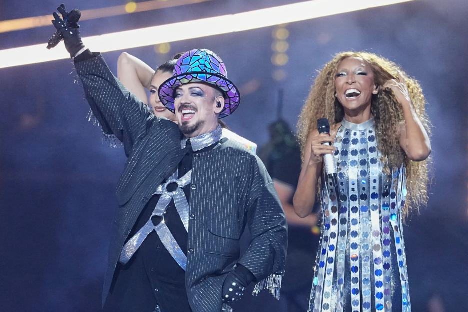 Boy George and a woman singing on stage at Eurovision.
