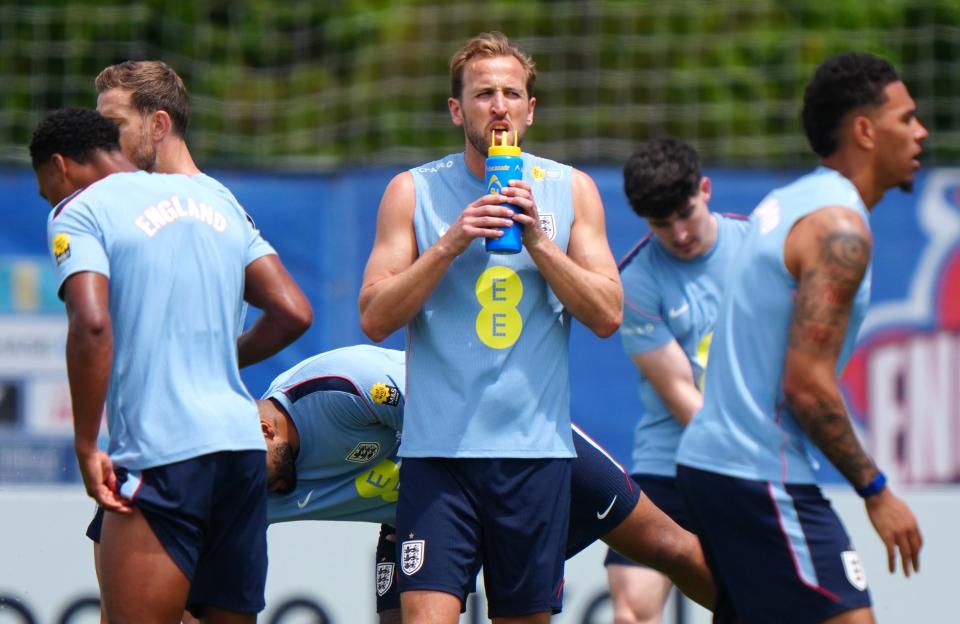 Harry Kane drinking from a water bottle during an England training session.