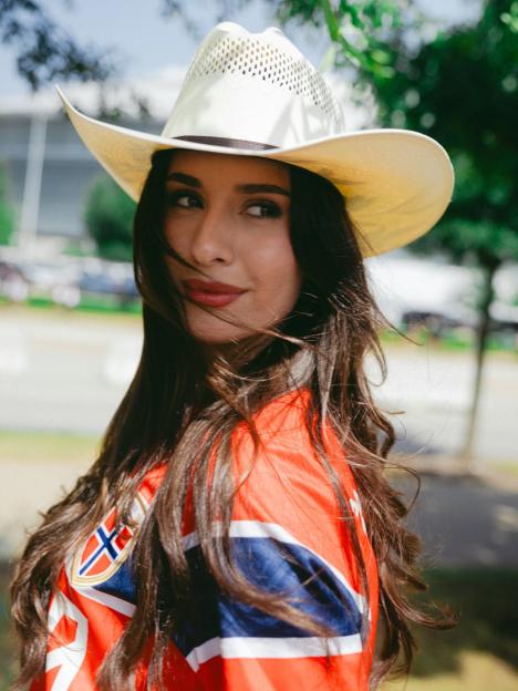 Isabel Haugseng Johansen wearing a cowboy hat and a red and blue shirt with a flag emblem.