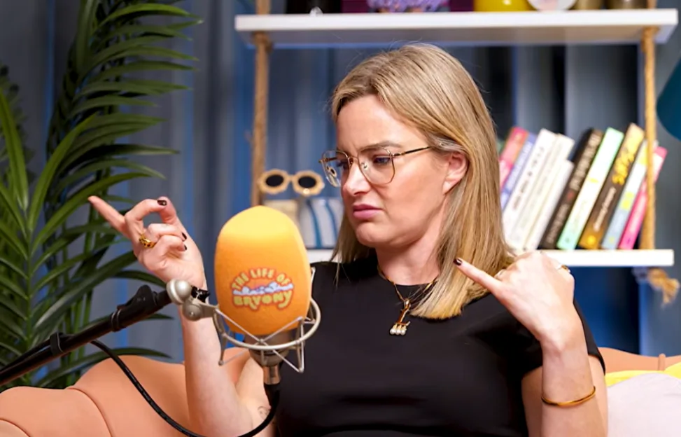 Lou Beckett gestures with both hands in a podcast interview.