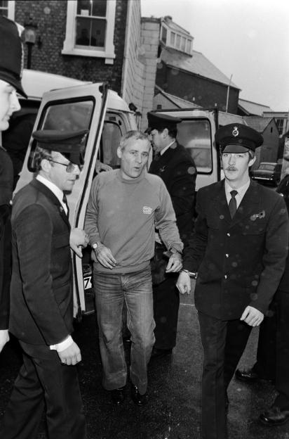 Peter Sutcliffe, the Yorkshire Ripper, and James Costello arriving at court, surrounded by police officers.