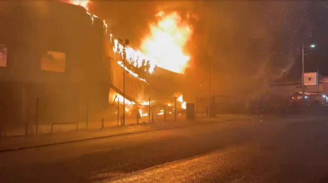 Arson Investigation Underway After Massive Blaze Engulfs City Centre Fashion Outlet, Originating from Nearby Caravan