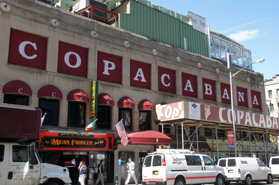 Exterior of the Copacabana nightclub building in Manhattan, New York, with large red signs spelling "COPACABANA".