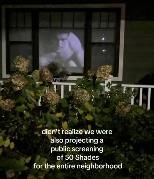 Movie "50 Shades" projected on a window for the neighborhood to see.