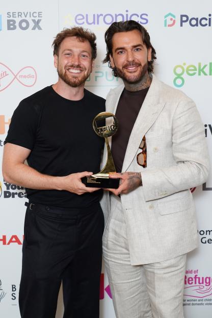 Sam Thompson and Pete Wicks holding their award for Best Podcast at the Tric Awards 2026.