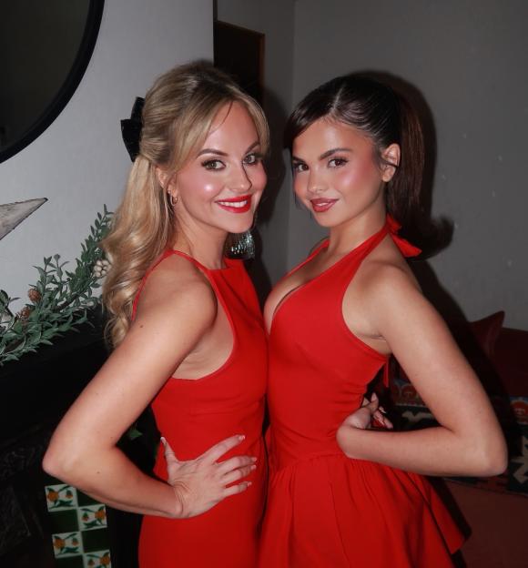 Tina O'Brien and daughter Scarlett pose in matching red dresses.