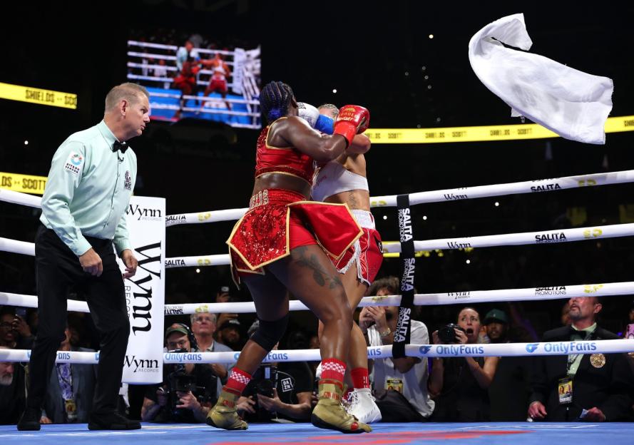 Claressa Shields and Kaye Scott boxing with a white towel thrown into the ring.