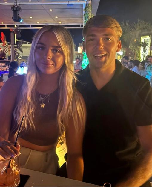 Olivia Allsopp and her boyfriend Ethan smiling in a bar.