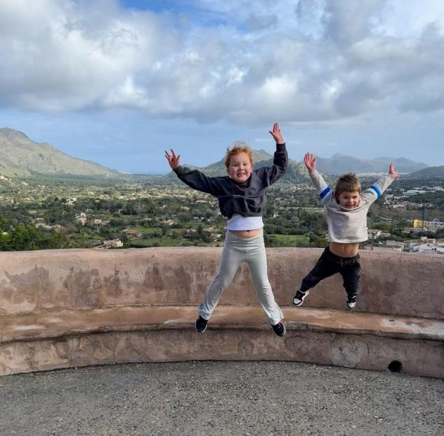 Melia and Jude jumping in the air in Majorca.