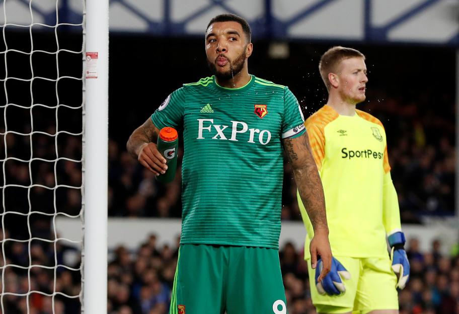 Watford's Troy Deeney spits water near Everton's Jordan Pickford.