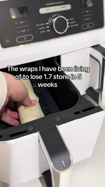 A person putting a wrap into an air fryer.
