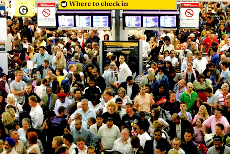 Crowds of people wait in the check-in area of Gatwick Airport after increased security due to a terror threat.