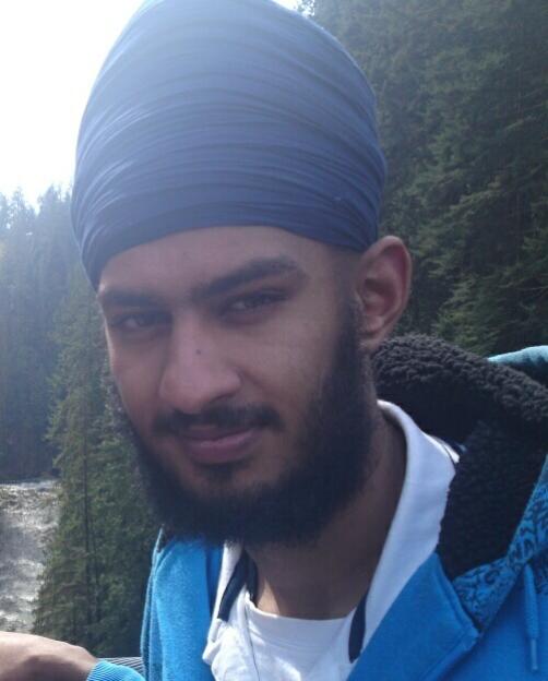 Gagandip Singh, a young man with a dark beard and blue turban, looking into the camera.