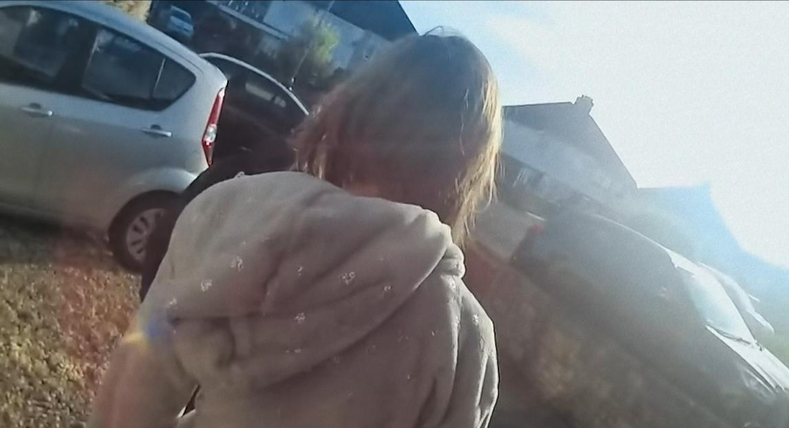 Lucy Letby turning away from the camera in a parking lot.