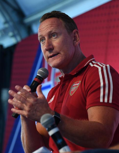 Former Arsenal player Ray Parlour speaking into a microphone.