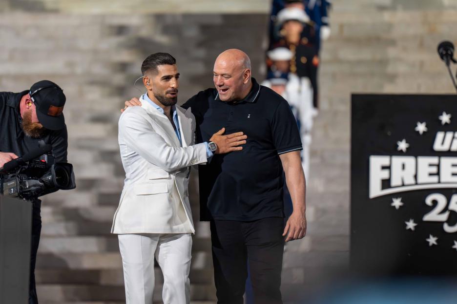 UFC Featherweight Champion Ilia "El Matador" Topuria pats UFC President Dana White on the chest at a press conference.