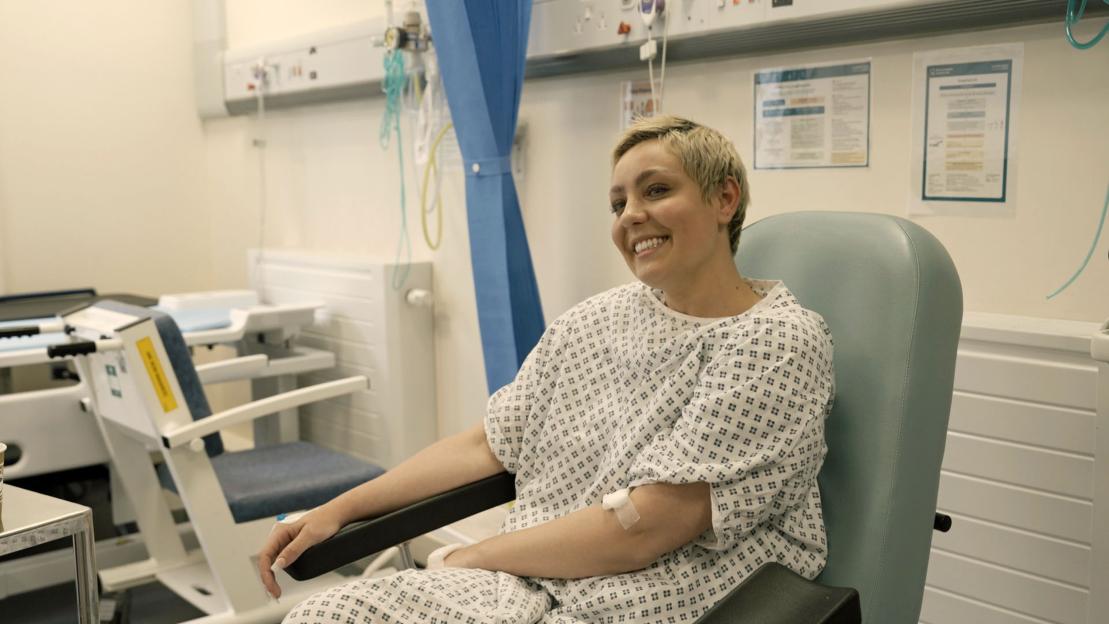 Amy Dowden smiling in a hospital gown.