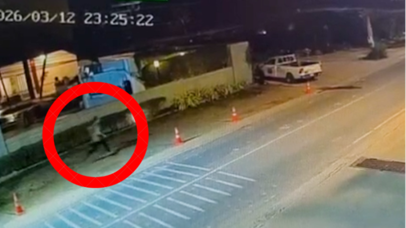 CCTV footage of a person running at night, highlighted by a red circle, with a white truck and building in the background.