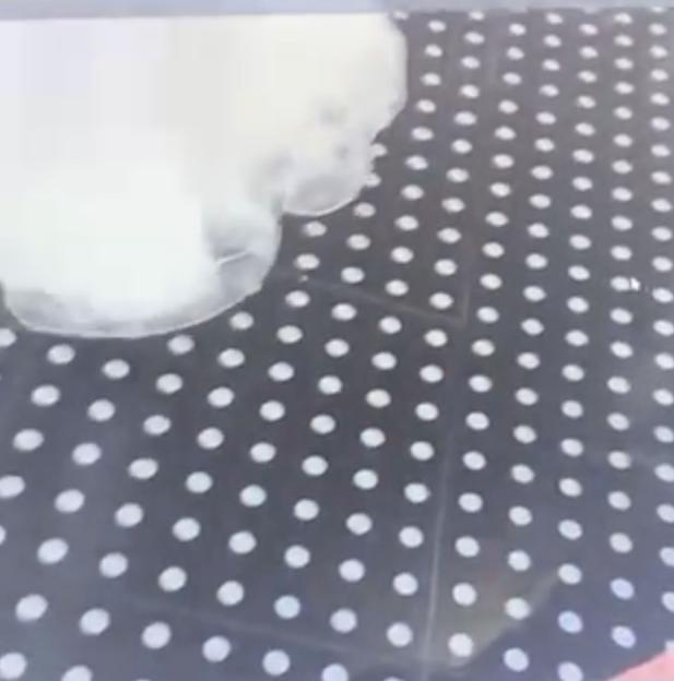 A black floor with white polka dots.