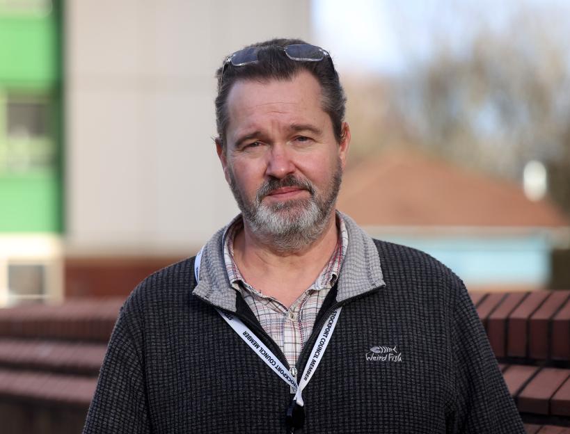 Cllr James Frizzell, a Stockport Council Member, wearing glasses on his head and a "Weird Fish" brand fleece.