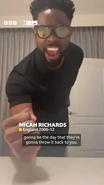 Micah Richards, in sunglasses, yells while holding his fist out, with text overlay from a BBC World Cup video.