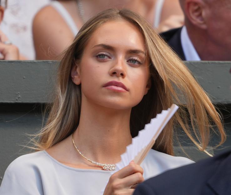 Laila Hasanovic, girlfriend of Jannik Sinner, holding a fan while watching a match at Wimbledon.