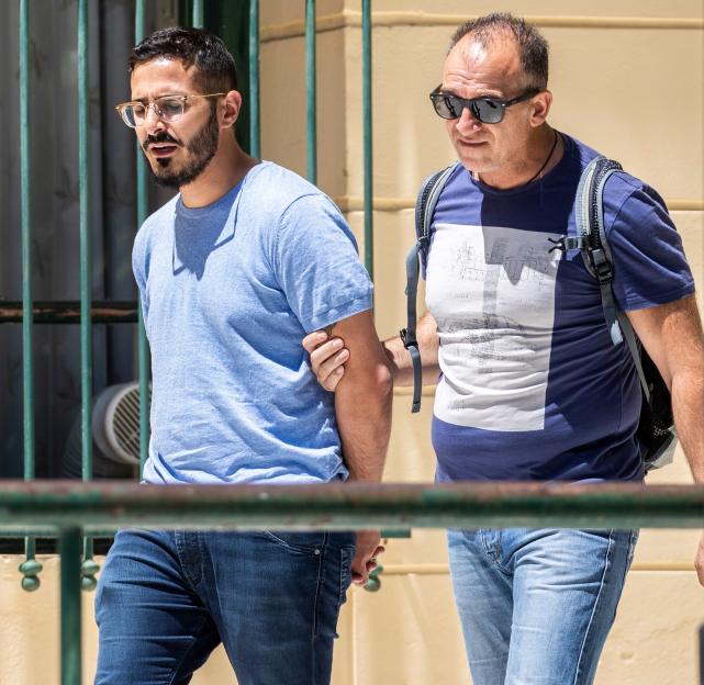 Simon Leviev being escorted by a man in Athens, Greece.