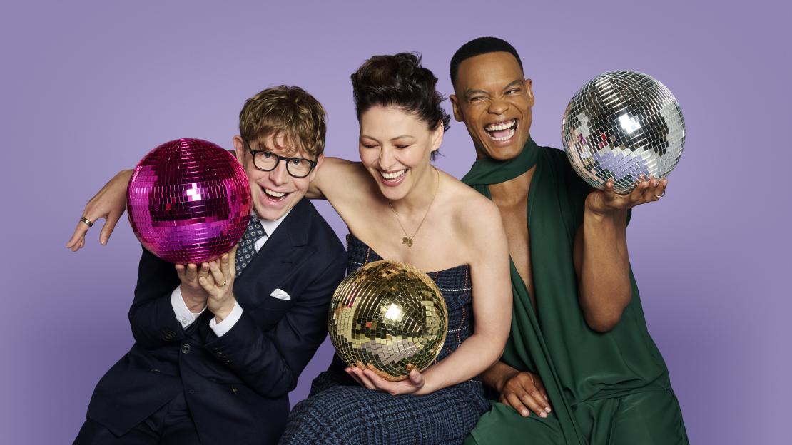 Josh Widdicombe, Emma Willis, and Johannes Radebe, the new hosts of Strictly Come Dancing, posing with disco balls.