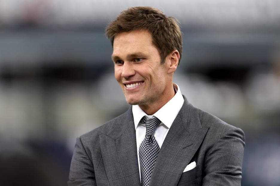 Tom Brady smiles at the Detroit Lions vs. Dallas Cowboys game.