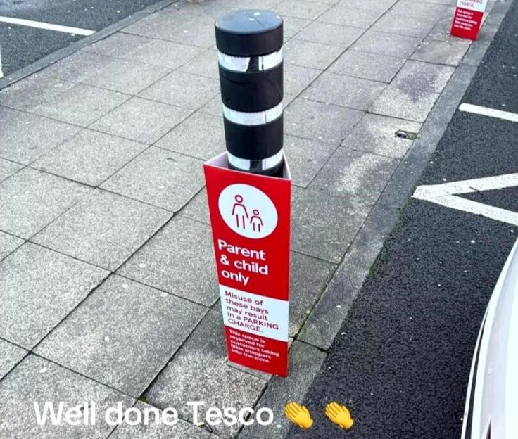 A sign for "Parent & child only" parking with a bollard.