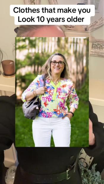 A woman in white pants and a colorful floral top with a bright yellow collar.