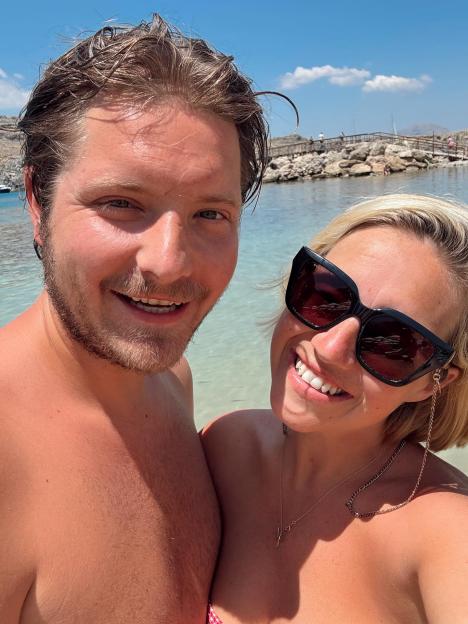 Kelsey Parker showing off her baby bump with her partner in Rhodes.