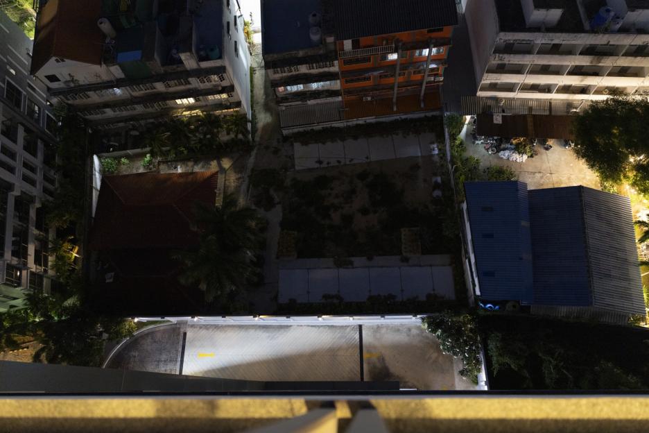 Overhead view of city buildings and alleyways at night.