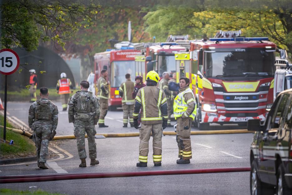 Firefighters and military personnel gathered at the scene of a fire at RAF Fairford.