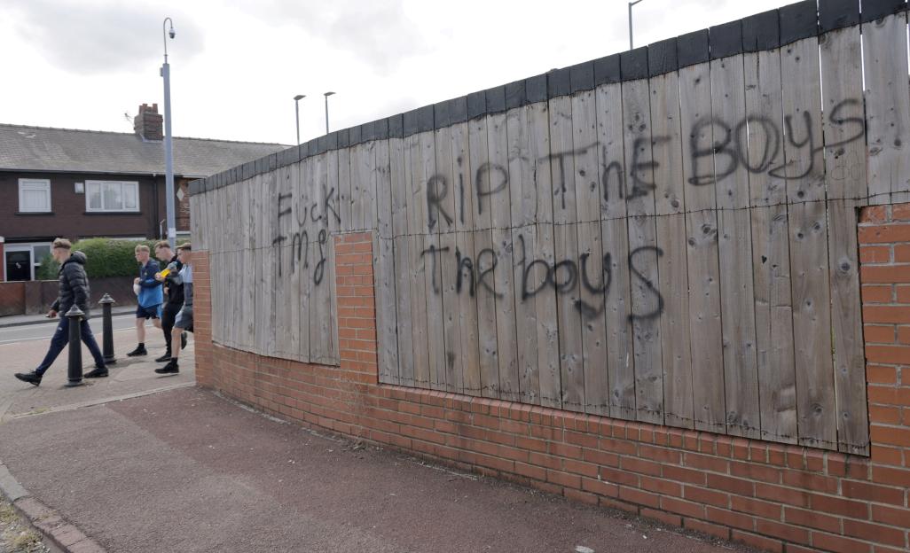 Graffiti on a wooden fence at Brambles Farm Estate, Middlesbrough.