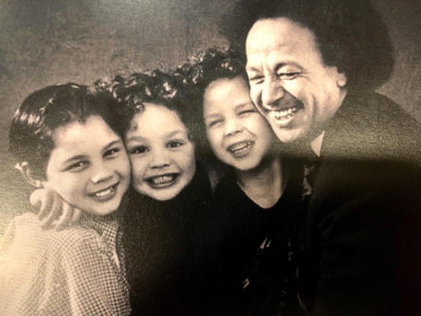 Black and white photo of Dougie James with three children.