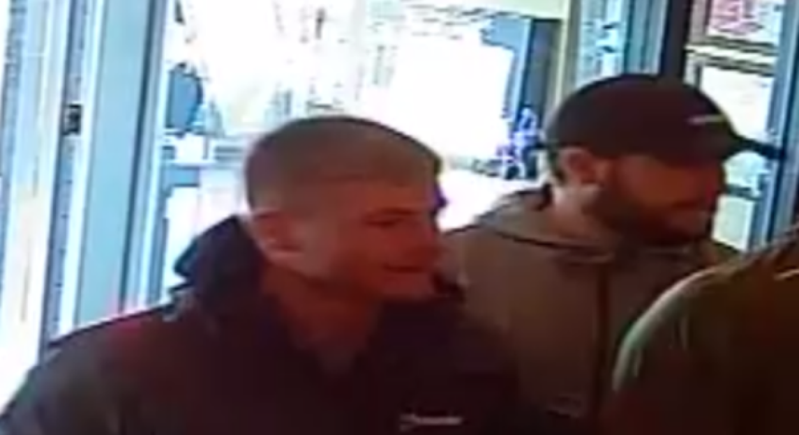 Two men, one with short hair and the other wearing a baseball cap, captured on CCTV.
