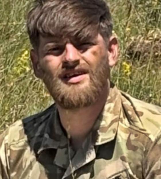 Sergeant Alex Cairnie, a 30-year-old soldier with a beard and mousy brown hair, wearing a camouflage uniform.