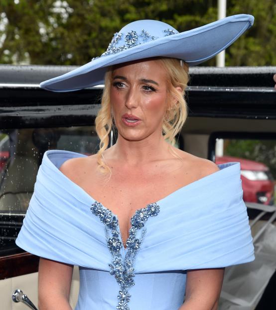 Paris Fury wearing a sky-blue off-the-shoulder gown and a large sky-blue hat with embellishments.