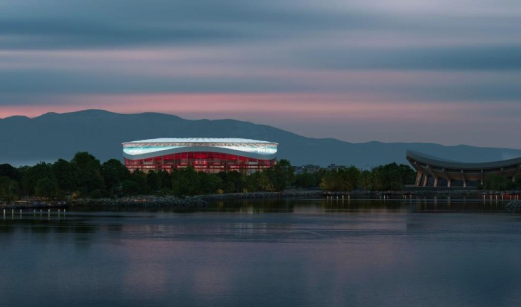 An illustration of Olympiacos stadium, a large, modern stadium with red and white lighting, at dusk, with mountains in the background and a body of water in the foreground.