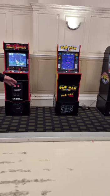Arcade games, including Mortal Kombat and Pac-Man, in a hotel games room.
