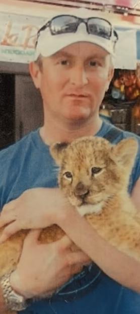 Paul Heyfron, the victim of a murder investigation, holding a lion cub.