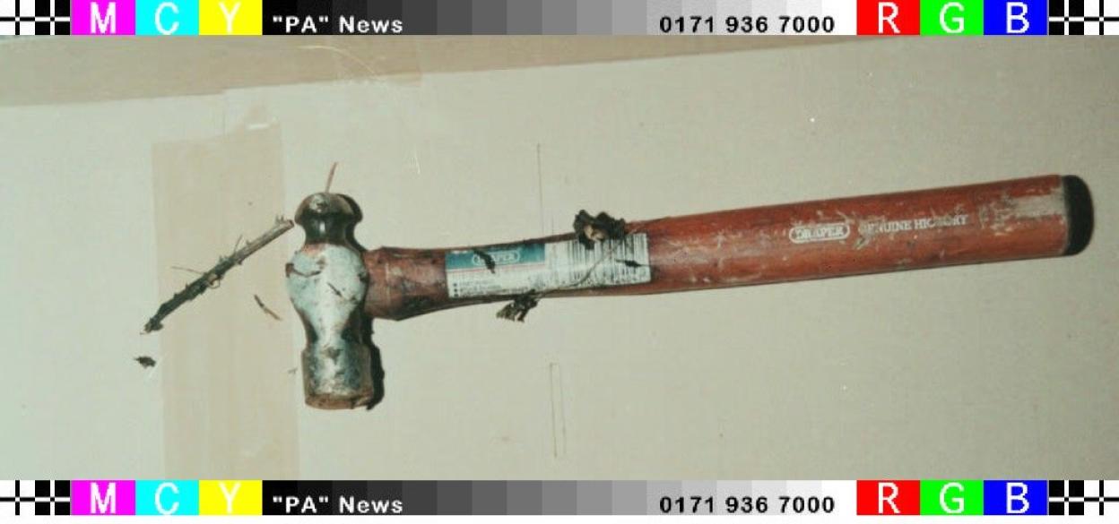 A hammer with a brown wooden handle and a metal head, found in a hedgerow near the murder scene of Lin and Megan Russell.